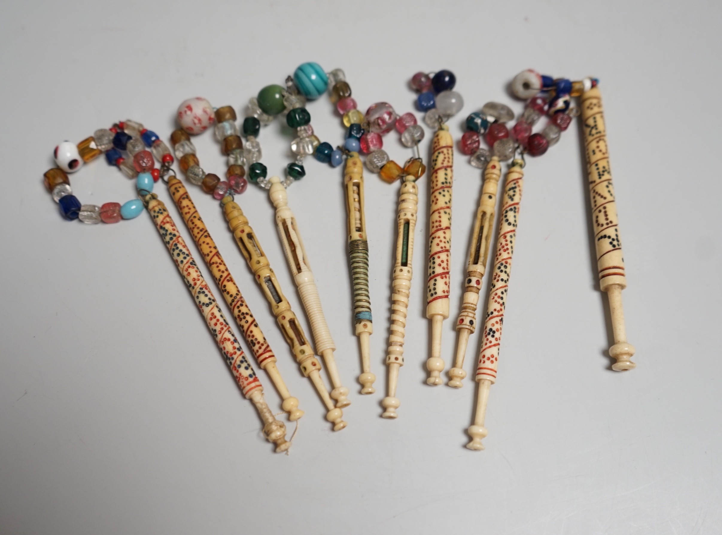 Five 19th century unusual reticulated bone lace bobbins with diagonal messages and five other ornately carved bobbins (10)